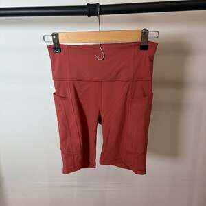 Athleta Ultimate Stash High Rise 7" Biker Shorts in Burnt Orange